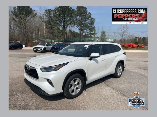 2024 Toyota Highlander LE in White — front three-quarter view